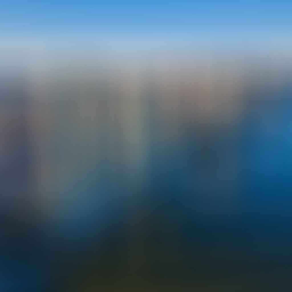Aerial view of Jersey City waterfront skyline with Newport towers and Manhattan skyline in background.