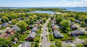 Aerial view of Huguenot Staten Island residential neighborhood with tree-lined streets.